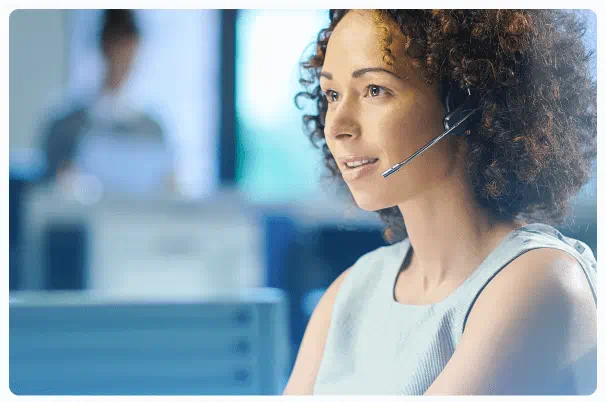 Female support team representative wearing a headset at Forexindextrading.com offices